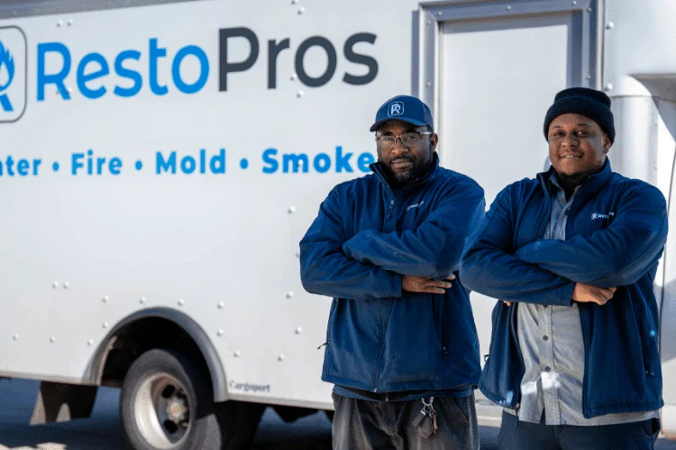 two RestoPros techs posing in front of company truck, RestoPros of Central Maryland
